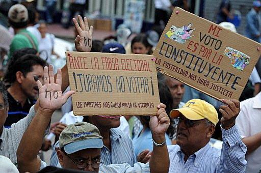 Supporters of Zelaya raise their painted hands calling the people not to vote in the November 29 "election", during a demonstration in Tegucigalpa.